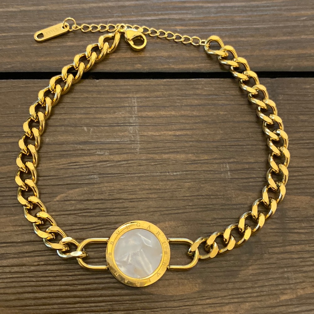 GOLD TITANIUM STEEL BRACELET ACCENTED WITH PEARL CIRCLE AND ROMAN NUMERALS